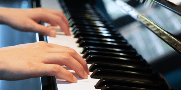 Close up of a piano student's hands on the keys
