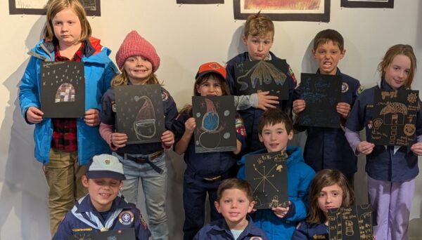 Local cub scouts visit PMAC. Scouts shown in their uniforms holding art projects they made.