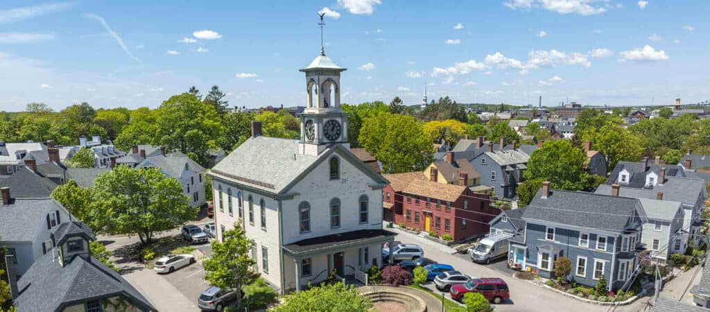 Aerial image of South Meeting House on a clear day with blue sky and surrounding houses