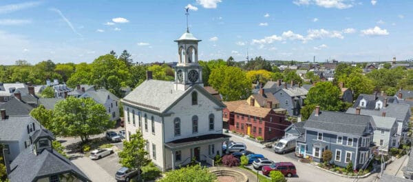 Aerial image of South Meeting House on a clear day with blue sky and surrounding houses