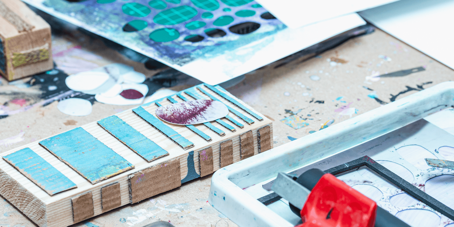 Supplies for collagraph printmaking laid out on a table