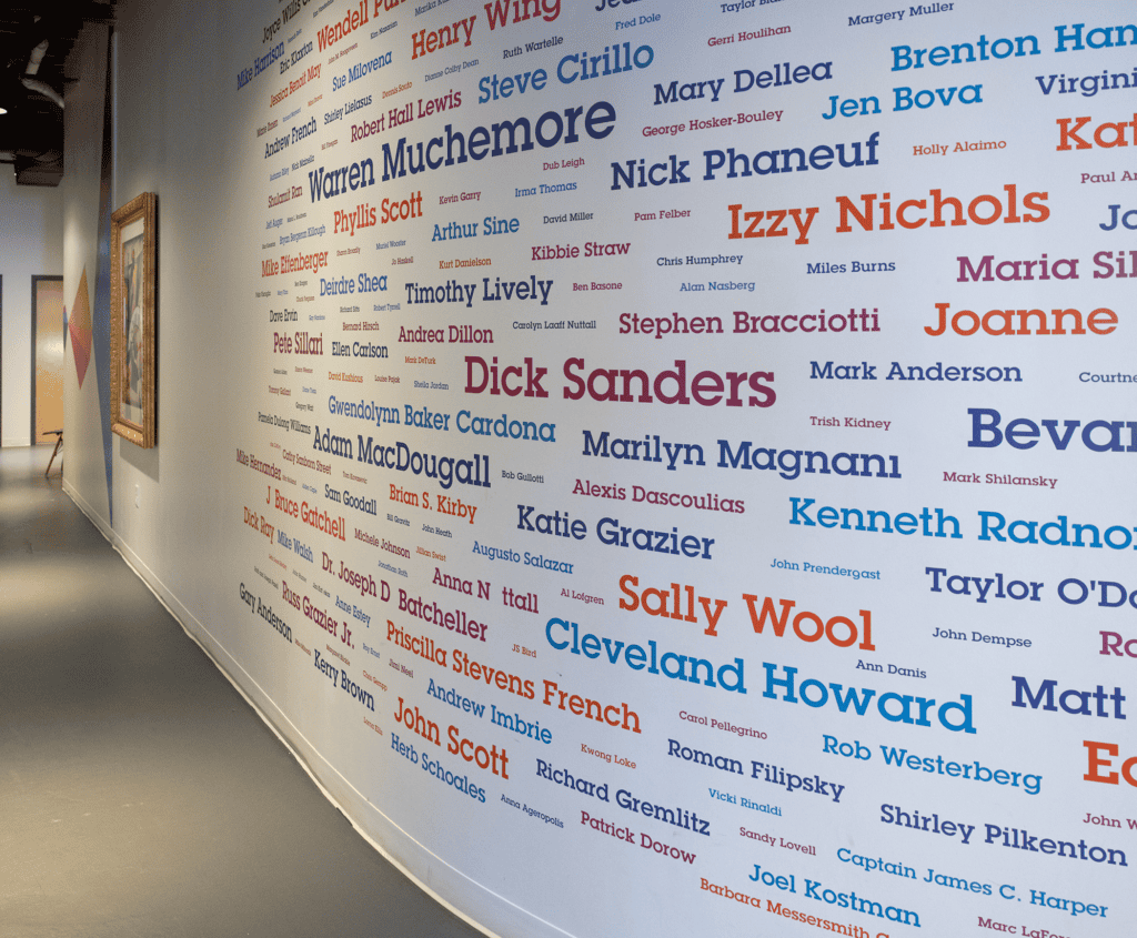 PMAC's Arts Mentor wall installation at 973 Islington Street shows many names of mentors in varying sizes and colors